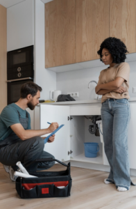 Home inspector examining a home's plumbing during a buyer inspection.