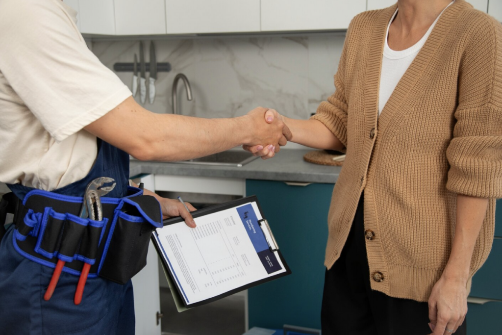 Homebuyer shaking hands with a home inspection professional after the inspection.
