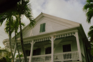 White older Florida home with palm trees in Sarasota or Port Charlotte.